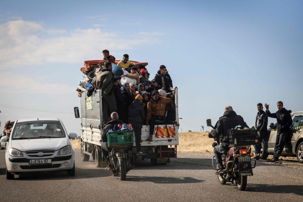 Palestinians ride a truck with some of their belongings as they flee Khan Yunis toward Rafah further south in the Gaza Strip, on January 25, 2024. (Photo by AFP)