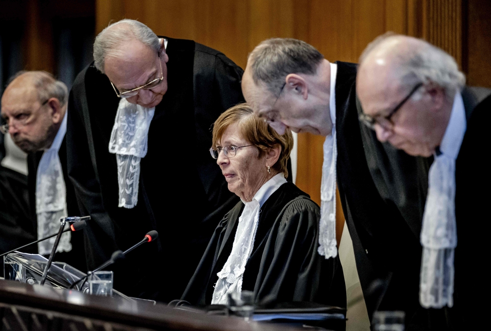 ICJ President Joan Donoghue (C) and ICJ judges arrive at the International Court of Justice (ICJ) prior to the verdict announcement in the genocide case against Israel, brought by South Africa, in The Hague on January 26, 2024. (Photo by Remko de Waal / ANP / AFP)