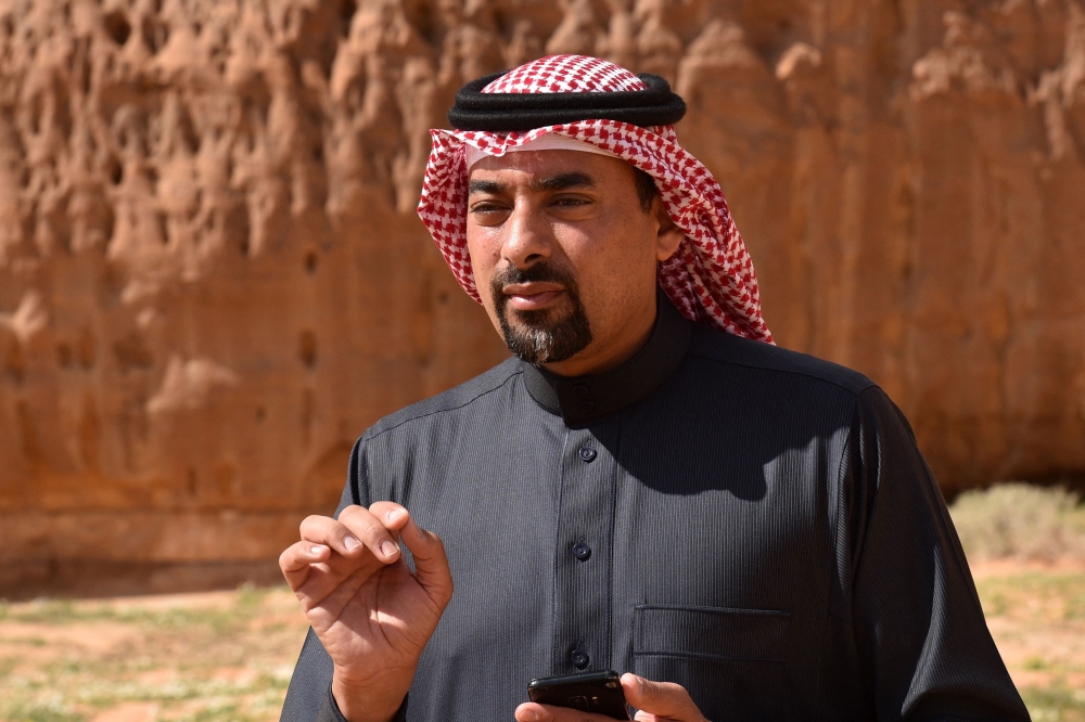 Amr bin Saleh Abdulrahman al-Madani, Saudi CEO of the Royal Commission for AlUla in the northwestern Medina region, speaks to an employee while touring the Sharaan Nature Reserve near the town of al-Ula in northwestern Saudi Arabia on February 11, 2019. Photo by FAYEZ NURELDINE / AFP