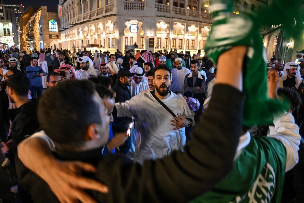 Saudi Arabia supporters gather on a street at the Souq Waqif in Doha on January 22, 2024, during the AFC Qatar 2023 Asian Cup. (Photo by Hector RETAMAL / AFP)
