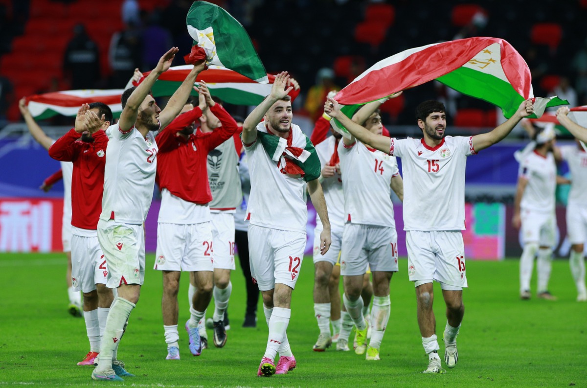 Tajikistan players celebrate their Round of 16 win.