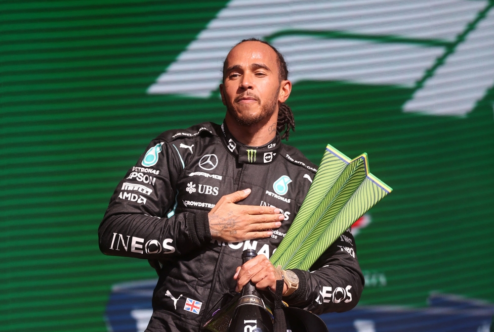 File: Mercedes' British driver Lewis Hamilton holds the trophy on the podium after winning Brazil's Formula One Sao Paulo Grand Prix at the Autodromo Jose Carlos Pace, or Interlagos racetrack, in Sao Paulo, on November 14, 2021. (Photo by Lars Baron / POOL / AFP)