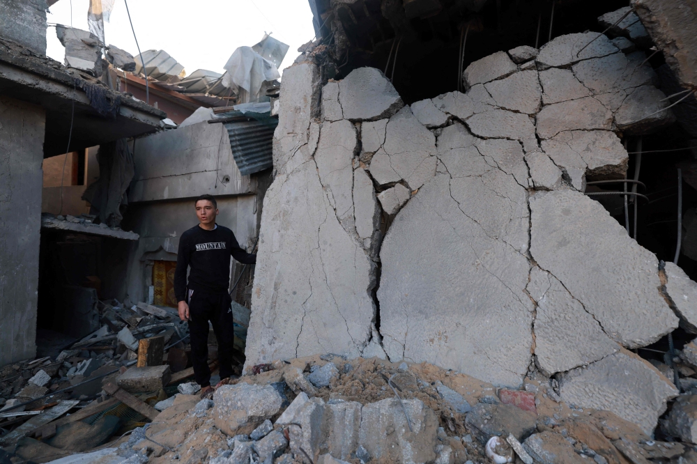 A man checks the destruction caused by Israeli bombardment in Rafah in the southern Gaza Strip on February 3, 2024. (Photo by Mohammed Abed / AFP)