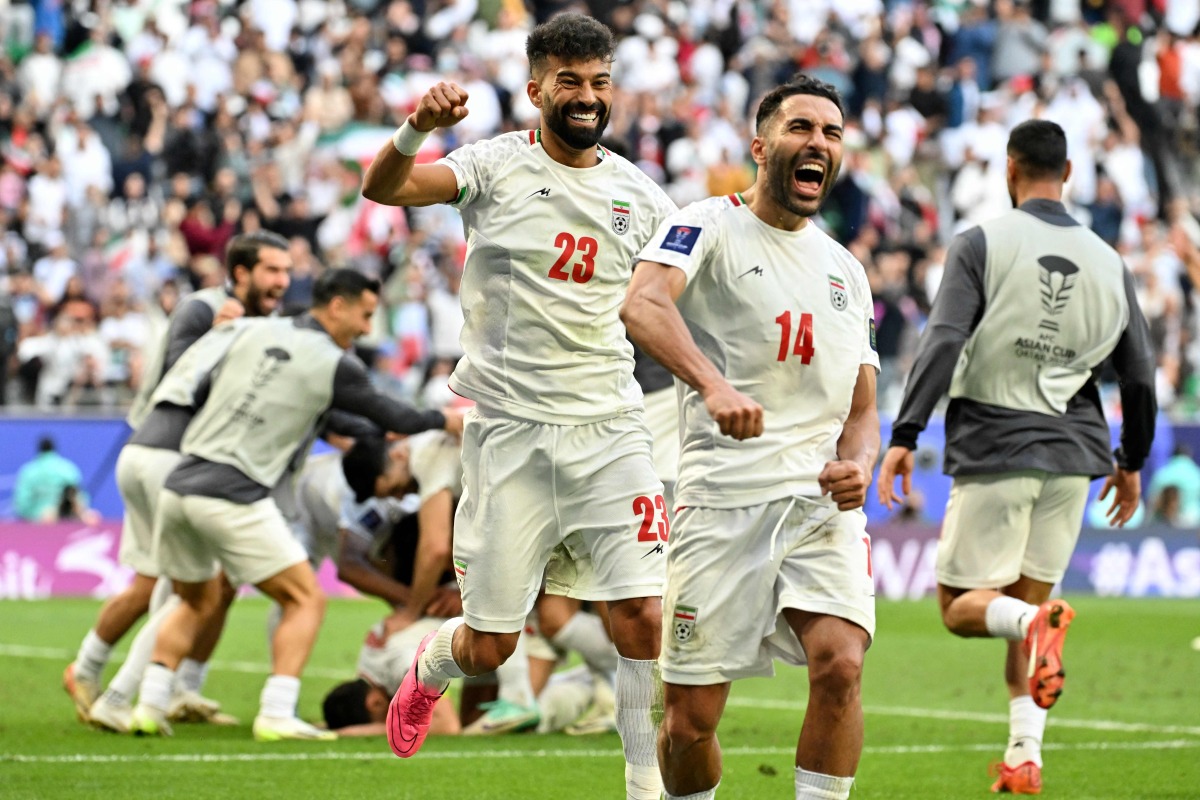 Iran's players celebrate their team's second goal during the Qatar 2023 AFC Asian Cup quarter-final football match between Iran and Japan at Education City Stadium in al-Rayyan, west of Doha, on February 3, 2024. (Photo by HECTOR RETAMAL / AFP)
