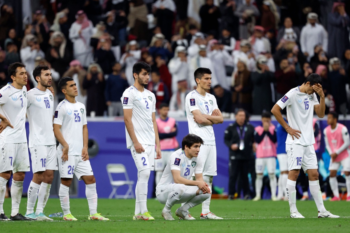 Uzbekistan’s players react after defeat against Qatar.