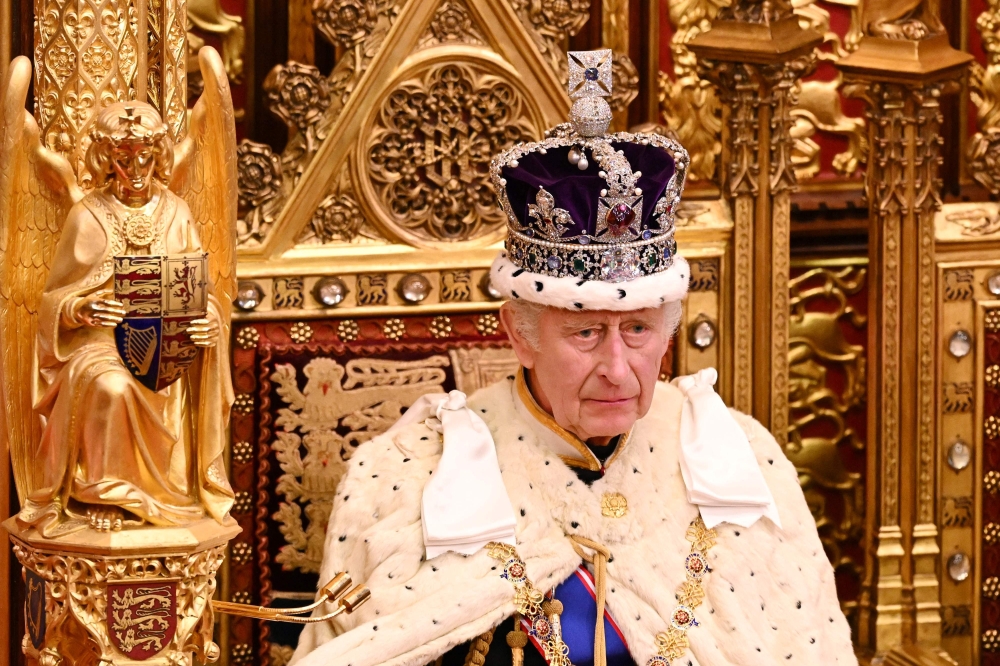 File: Britain's King Charles III, wearing the Imperial State Crown and the Robe of State, sits on The Sovereign's Throne in the House of Lords chamber, during the State Opening of Parliament, at the Houses of Parliament, in London, on November 7, 2023. (Photo by Leon Neal / POOL / AFP)