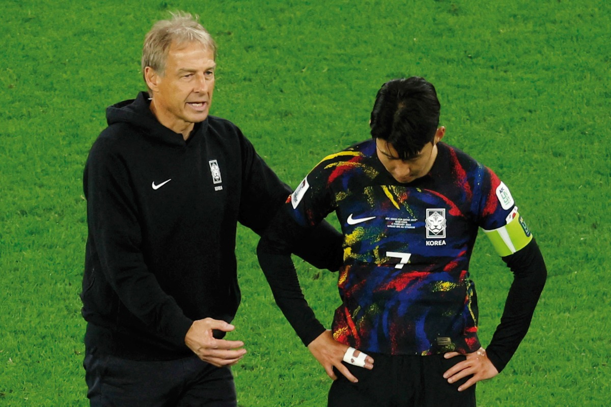 South Korea coach Jurgen Klinsmann consoles Son Heung-min after the loss. AFP