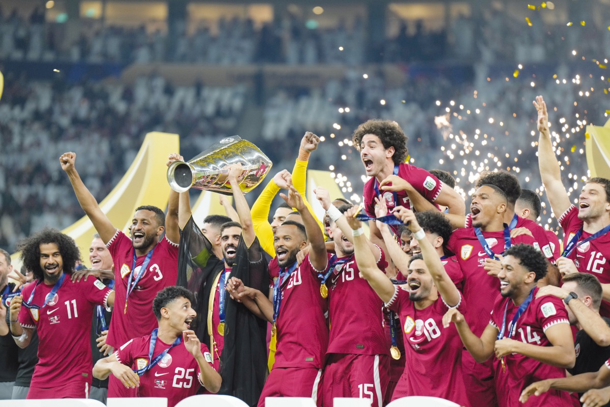 Qatar players celebrate with the trophy on Saturday night.