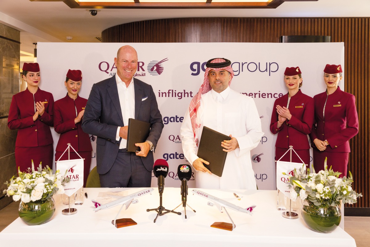 Qatar Airways Group Chief Executive Officer Engr Badr Mohammed Al Meer and CEO of gategroup, Christoph Schmitz, along with Qatar Airways cabin crew during the signing agreement.