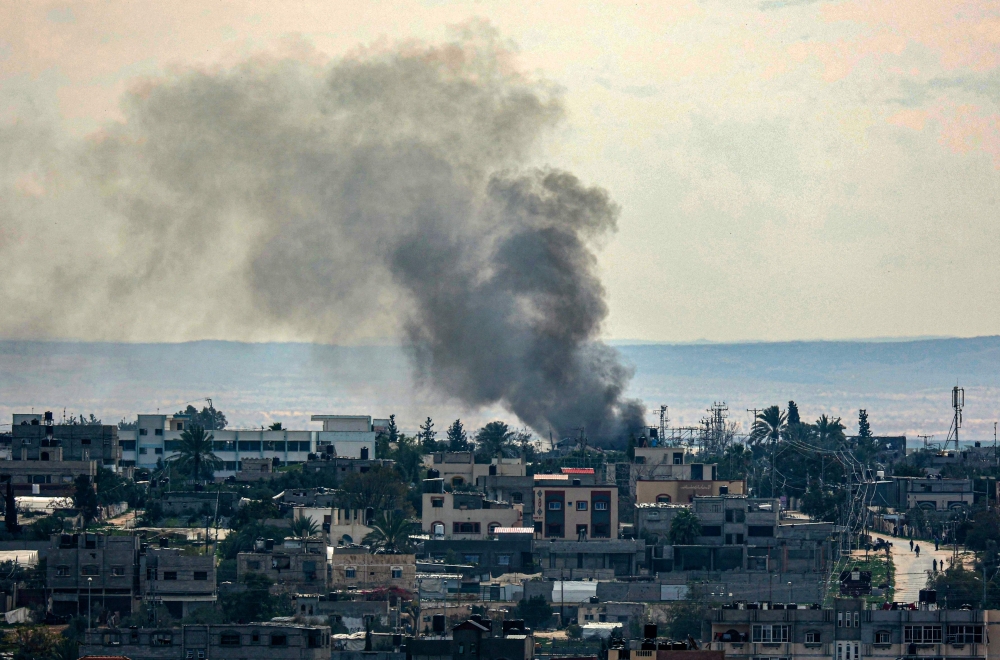 This picture shows smoke billowing following Israeli bombardments over east Rafah in the southern Gaza Strip on February 13, 2024. (Photo by SAID KHATIB / AFP)
