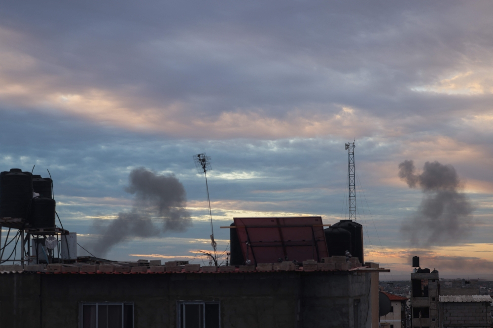 Smoke billows during Israeli bombardment over Rafah in the southern Gaza Strip on February 13, 2024. (Photo by MOHAMMED ABED / AFP)
