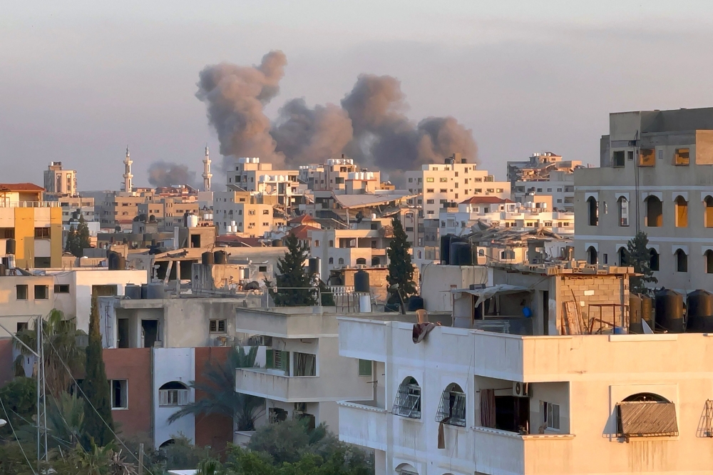 A picture taken in Gaza City shows smoke billowing in the background during Israeli bombardment on February 20, 2024. (Photo by AFP)