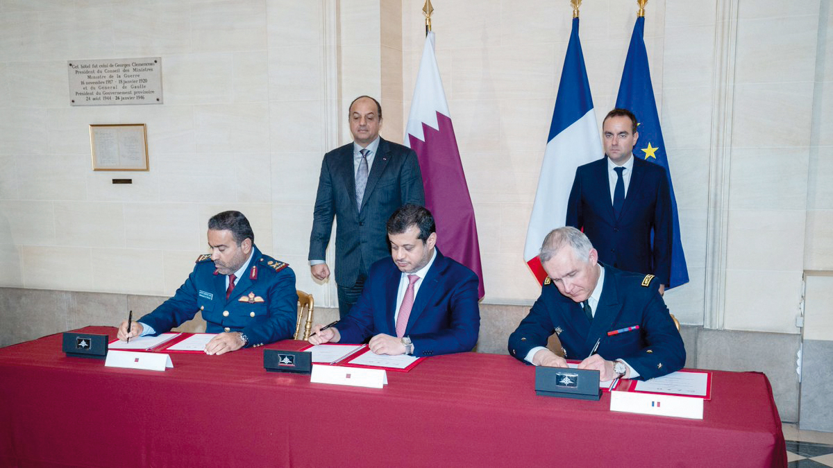 Deputy Prime Minister and Minister of State for Defense Affairs H E Dr. Khalid bin Mohammed 
Al Attiyah (left, standing) and Minister of the Armed Forces of France H E Sebastien Lecornu look on as officials sign documents in Paris. 