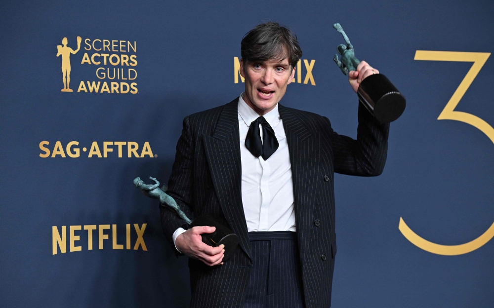 Irish actor Cillian Murphy poses in the press room with the awards at the Shrine Auditorium in Los Angeles, February 24, 2024. (Photo by Robyn Beck / AFP)