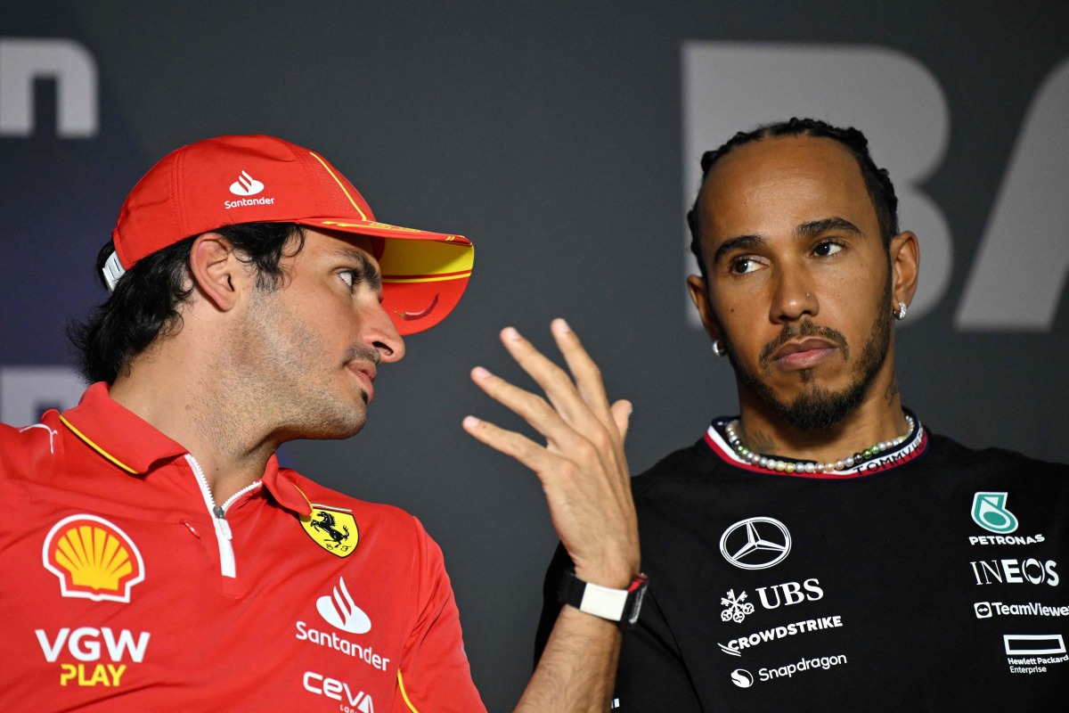 Ferrari’s Carlos Sainz Jr speaks with Mercedes’ Lewis Hamilton (right) at a press conference. AFP