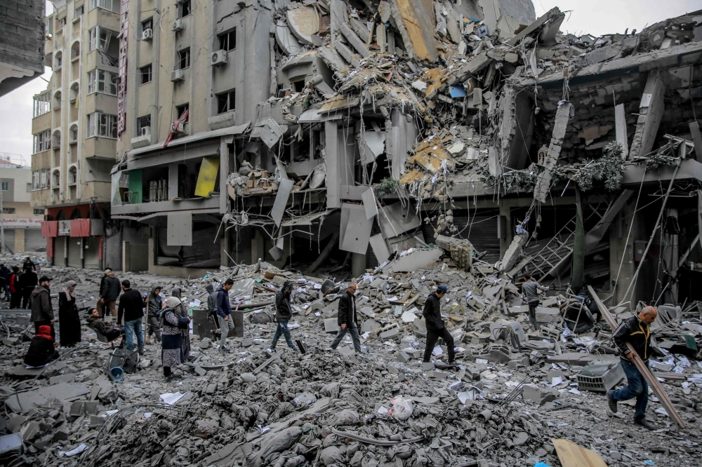  Palestinians walk amid the rubble of houses destroyed by Israeli bombardment in Gaza City on March 3, 2024. (Photo by AFP)
 