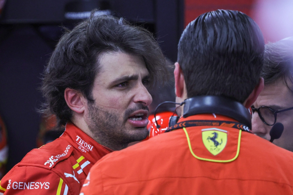 Ferrari's Spanish driver Carlos Sainz Jr talks to team members in the garage after the first practice session of the Saudi Arabian Formula One Grand Prix at the Jeddah Corniche Circuit in Jeddah on March 7, 2024. (Photo by Giuseppe CACACE / AFP)