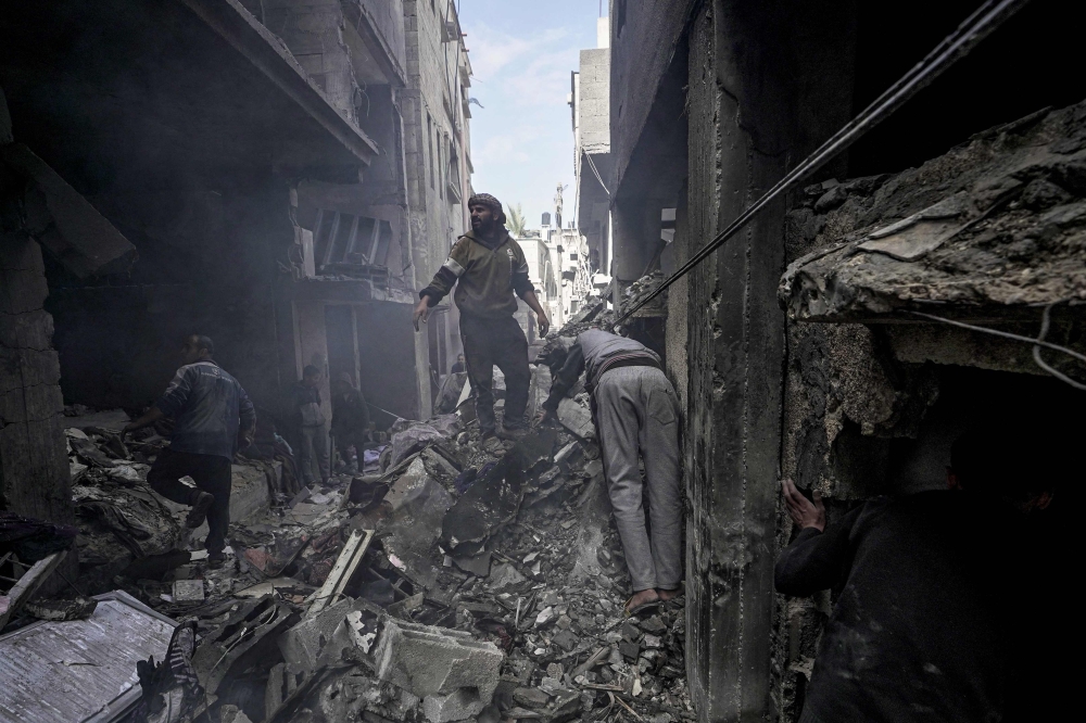 Palestinians inpect the rubble of a building in Deir el-Balah following Israeli bombardment, in the central Gaza Strip, on March 8, 2024, amid ongoing battles between Israel and Hamas. (Photo by AFP)
