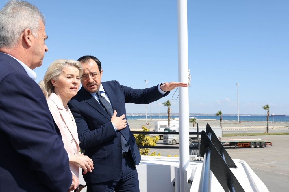 A handout picture provided by the Cypriot government's Press and Information Office (PIO) shows Cyprus' President Nikos Christodoulides (R) and President of the European Commission Ursula von der Leyen inspecting the Larnaca Port, in Larnaca, Cyprus. (Photo by Andreas Loucaides / PIO / AFP)