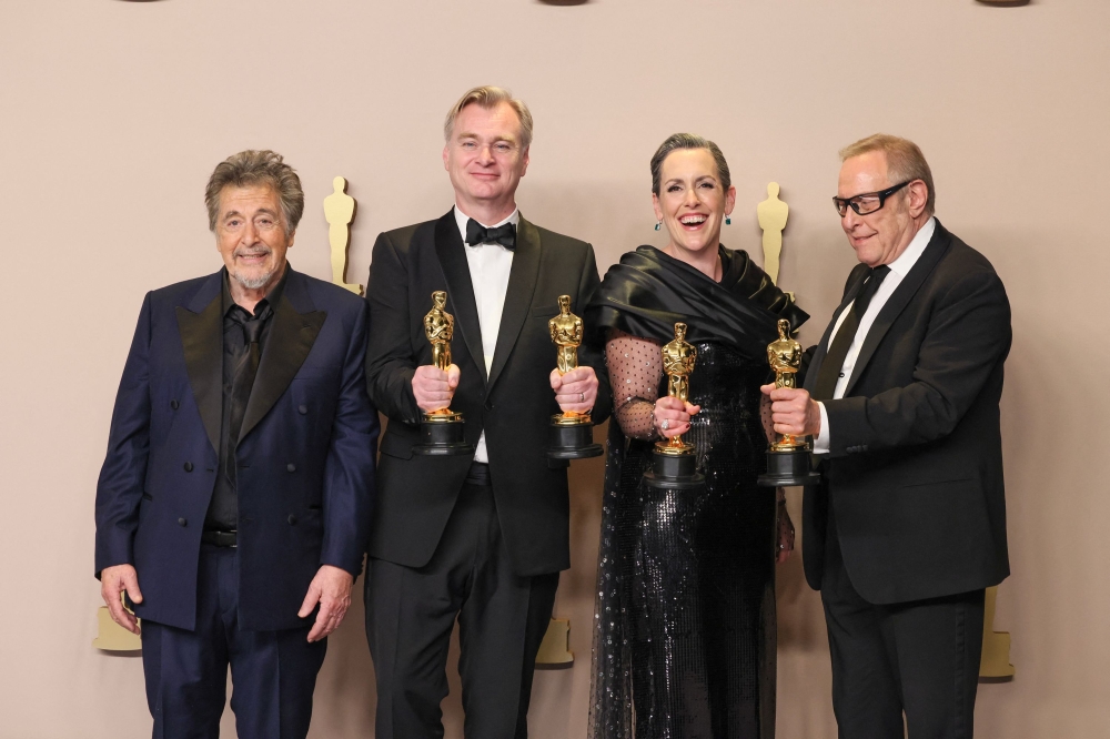 (L-R) Al Pacino poses with Christopher Nolan, Emma Thomas, and Charles Roven, winners of the Best Picture award for “Oppenheimer”, in the press room during the 96th Annual Academy Awards at Ovation Hollywood on March 10, 2024 in Hollywood, California. Rodin Eckenroth/Getty Images/AFP 