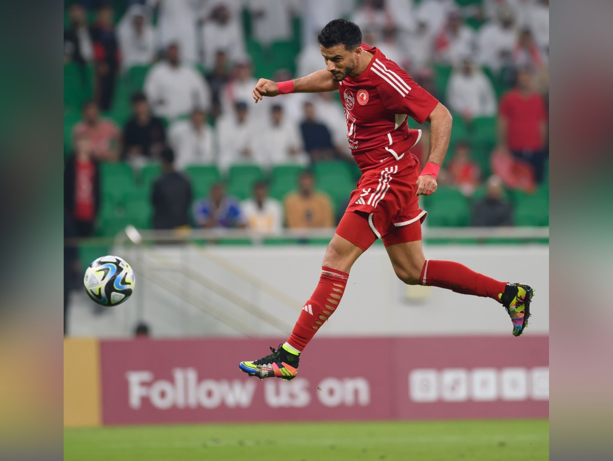 Al Arabi's Omar Al Somah heads the ball to score their second goal against Al Sadd.