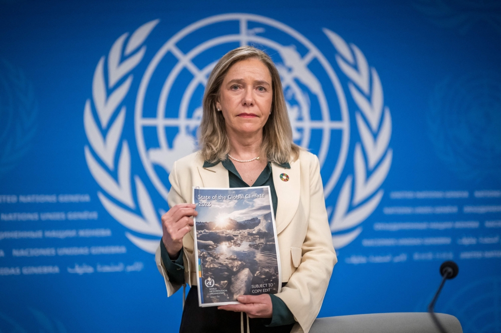 World Meteorological Organization (WMO) Secretary-General Celeste Saulo poses with the WMO's 2023 global climate report prior to a press conference in Geneva, on March 19, 2024. (Photo: Fabrice Coffrini / AFP)