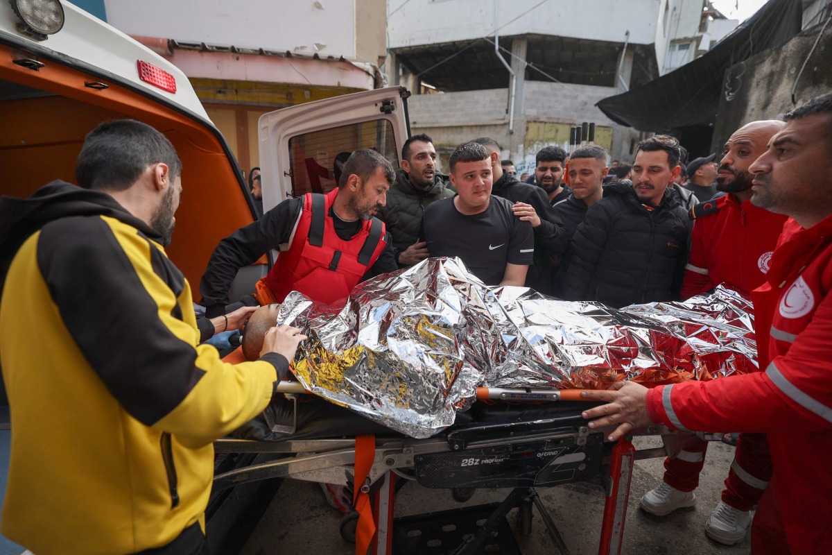 Palestinian medics transport the body of a man killed in an earlier Israeli raid at the Nur Shams refugee camp to a hospital in nearby Tulkarem in the occupied West Bank on March 21, 2024, amid a surge of violence in the Israel-occupied West Bank. (Photo by Jaafar ASHTIYEH / AFP)
