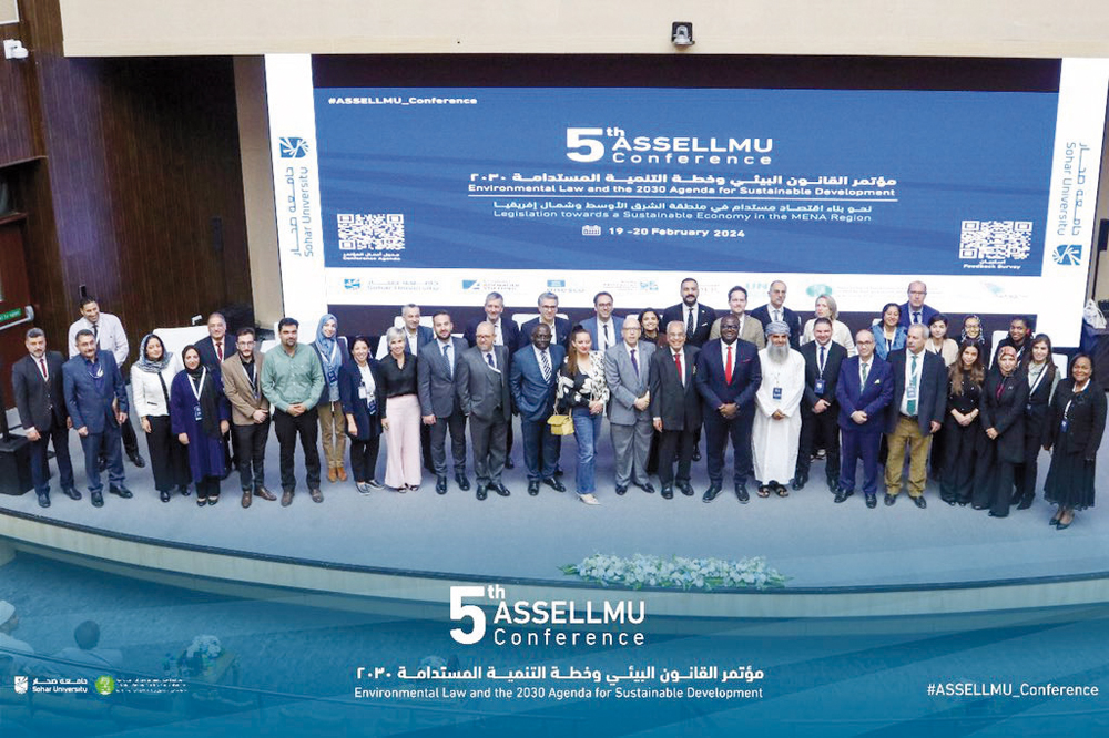 Speakers and attendees during a group photo at the conference.