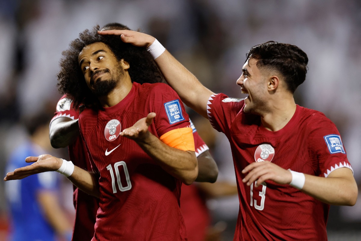 Qatar’s captain Akram Afif (left) celebrates with Ahmed Al Rawi after scoring his team’s third goal against Kuwait, yesterday. AFP