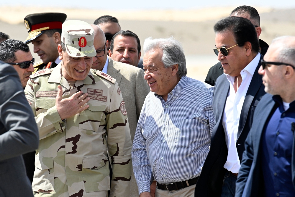 UN Secretary-General Antonio Guterres (C) walks on the tarmac, upon landing at Egypt's al-Arish Airport, near the Rafah border with the Gaza Strip on March 23, 2024. (Photo by Khaled Desouki / AFP)