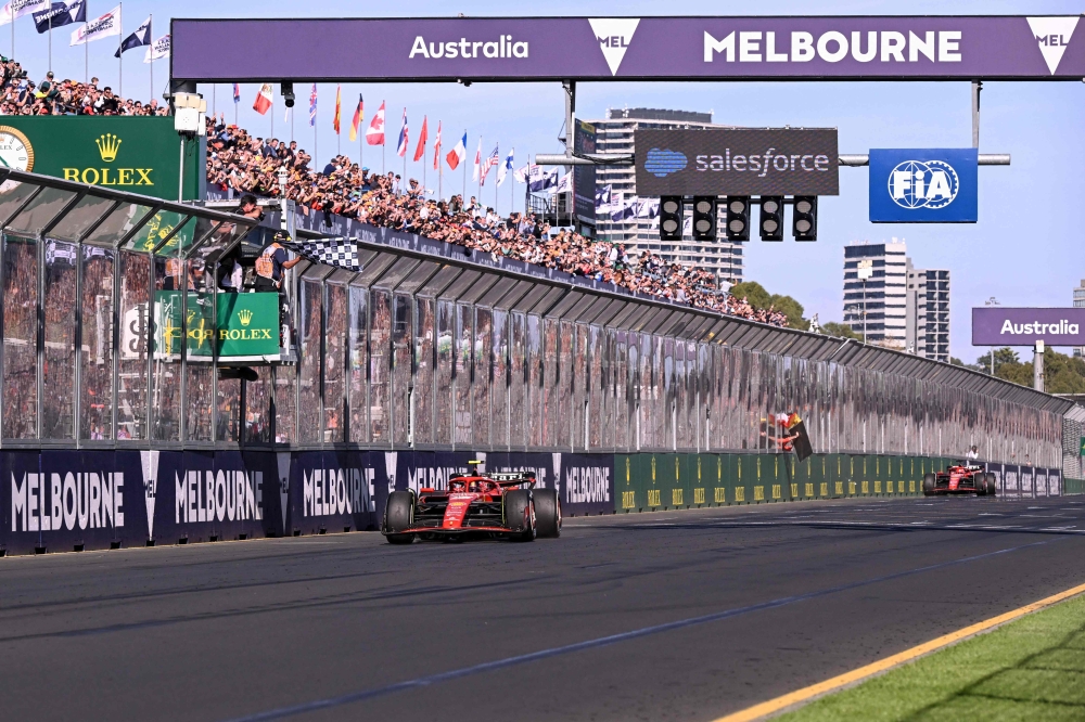 Ferrari's Spanish driver Carlos Sainz Jr crosses the finish line to win ahead of Ferrari's Monegasque driver Charles Leclerc during the Australian Formula One Grand Prix at Albert Park Circuit in Melbourne on March 24, 2024. (Photo by William West / AFP)