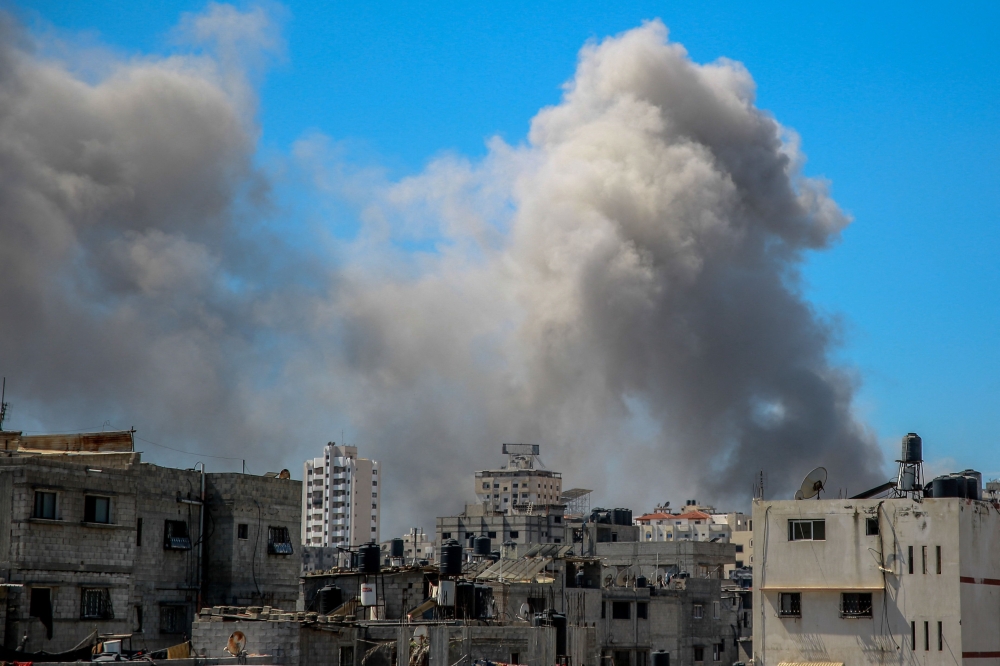 A picture shows smoke billowing after Israeli bombardment in the vicinity of the Al-Shifa hospital in Gaza City on March 23, 2024. (Photo by AFP)