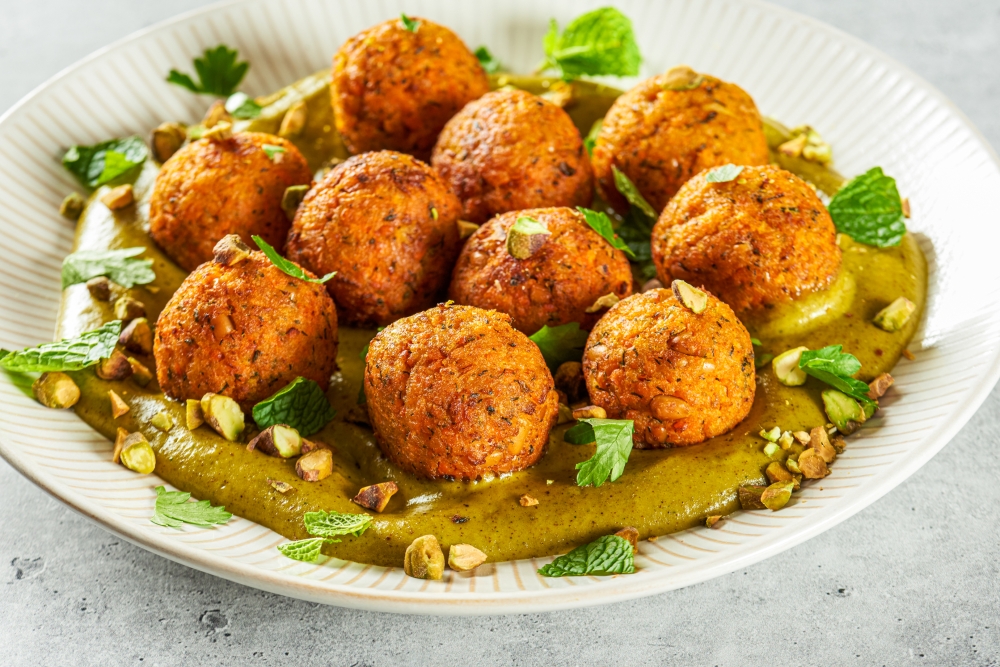 Carrot fritters with pistachio sauce. Rey Lopez for The Washington Post/food styling by Lisa Cherkasky for The Washington Post