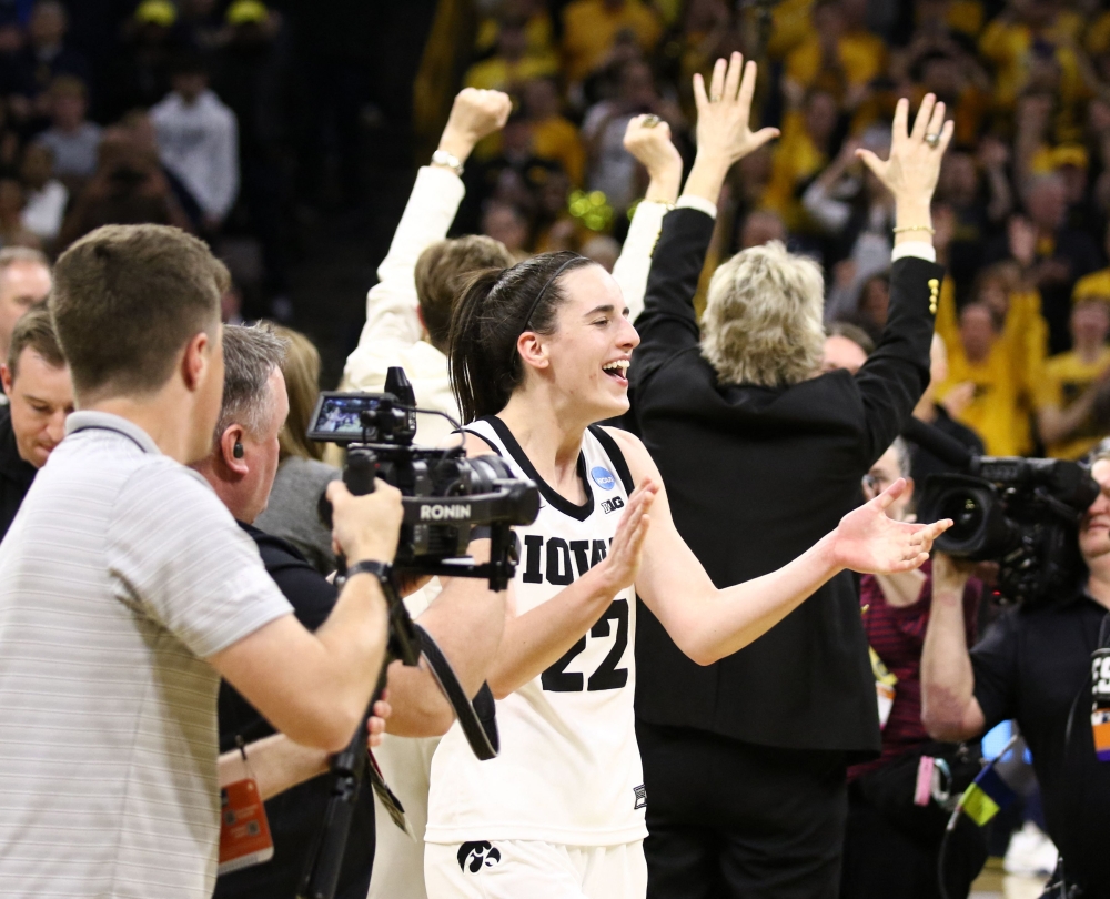 Guard Caitlin Clark #22 of the Iowa Hawkeyes celebrates after the game against the West Virginia Mountaineers during their second round match-up in the 2024 NCAA Division 1 Women's Basketball Championship at Carver-Hawkeye Arena on March 25, 2024 in Iowa City, Iowa. (Photo by Matthew Holst / GETTY IMAGES NORTH AMERICA / Getty Images via AFP)
