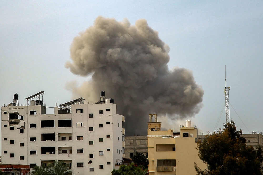 Smoke rises above buildings during an Israeli strike in the vicinity of the al-Shifa hospital in Gaza City on March 28, 2024. (Photo by AFP)