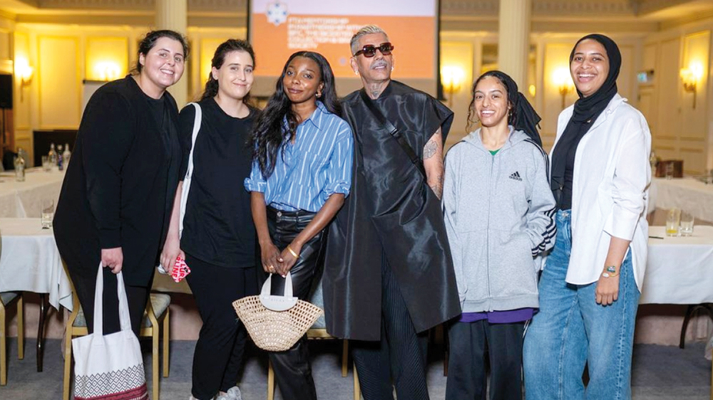 Qatar-based fashion designers pose for a photograph.