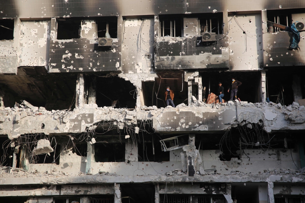 Palestinians inspect the damage at Gaza's Al-Shifa hospital after the Israeli military withdrew from the complex housing the hospital on April 1, 2024. (Photo by AFP)