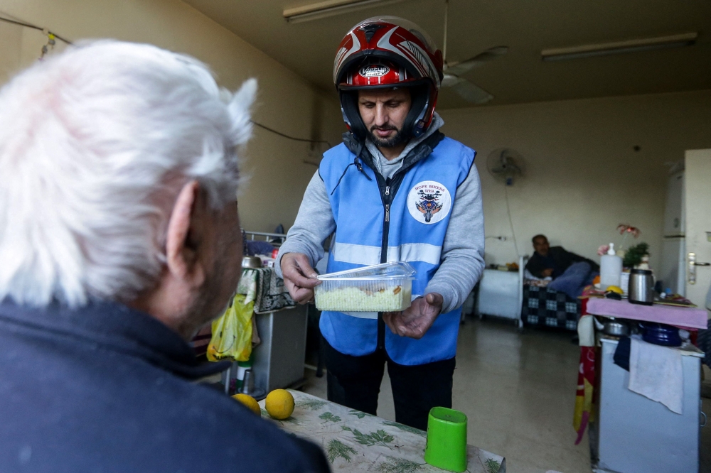 Members of motorcycle club Hope Bikers Syria help distribute 