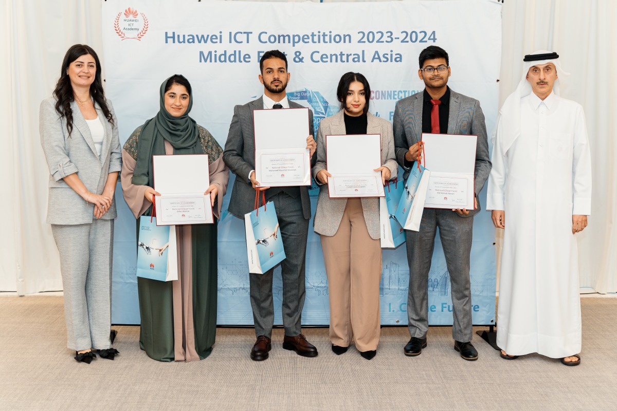 Officials pose for a group photo with students during the awards ceremony.