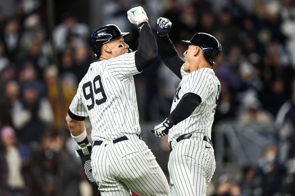 Anthony Rizzo #48 of the New York Yankees celebrates his home run with Aaron Judge #99 of the New York Yankees during the fifth inning of the game against the Toronto Blue Jays at Yankee Stadium on April 06, 2024 in New York City. (Photo by Dustin Satloff / GETTY IMAGES NORTH AMERICA / Getty Images via AFP)
