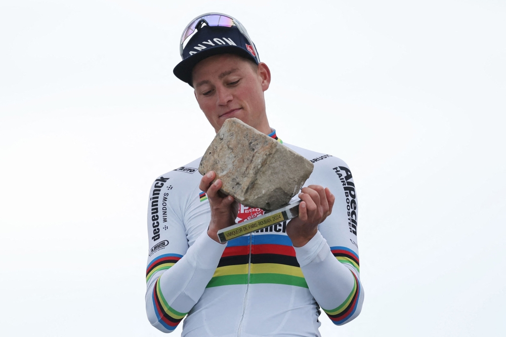 Alpecin - Deceuninck team's Dutch rider Mathieu Van Der Poel celebrates on the podium after winning the 121st edition of the Paris-Roubaix one-day classic cycling race, 260km between Compiegne and Roubaix, northern France, on April 7, 2024. (Photo by Francois LO PRESTI / AFP)
