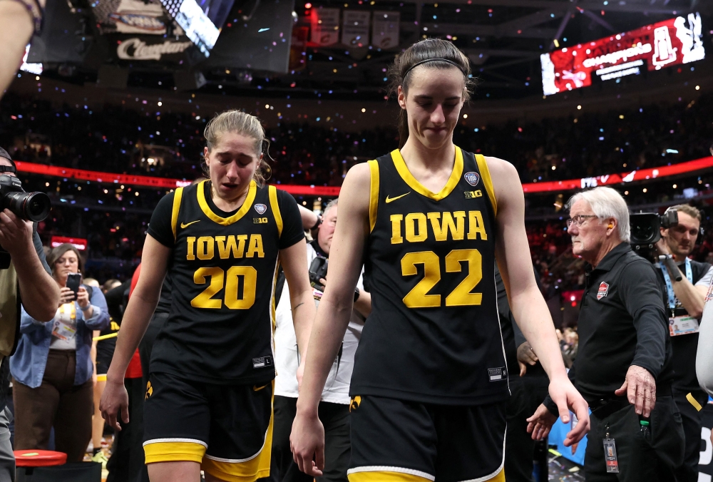 Caitlin Clark #22 and Kate Martin #20 of the Iowa Hawkeyes walk off the court after losing to the South Carolina Gamecocks in the 2024 NCAA Women's Basketball Tournament National Championship at Rocket Mortgage FieldHouse on April 07, 2024 in Cleveland, Ohio. (Photo by Steph Chambers / GETTY IMAGES NORTH AMERICA / Getty Images via AFP)
