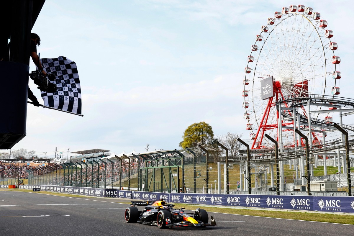 A race official waves the chequered flag as Red Bull Racing's Dutch driver Max Verstappen wins the Formula One Japanese Grand Prix race at the Suzuka circuit in Suzuka, Mie prefecture on April 7, 2024. (Photo by KIM Kyung-Hoon / POOL / AFP)