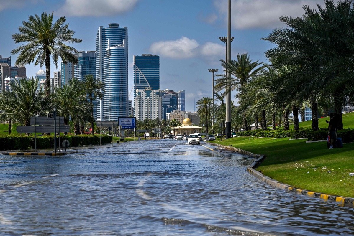 A picture shows a flooded street following heavy rains in Sharjah on April 17, 2024. (Photo by Ahmed RAMAZAN / AFP)
