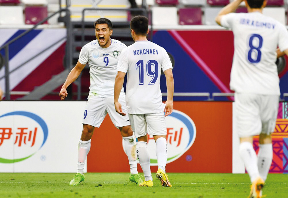 Uzbekistan’s Ulugbek Khoshimov (left) celebrates after scoring team’s second goal. PIC: AFC