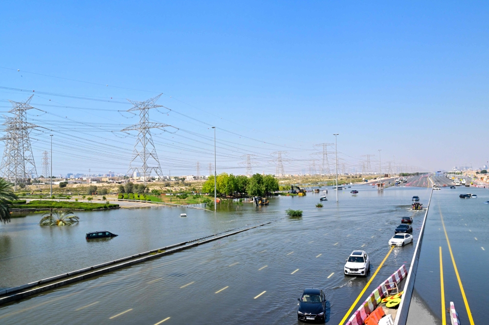 Cars are stranded on a flooded al-Khalil road in the al-Barsha area in Dubai following heavy rains on April 18, 2024. Photo by Giuseppe CACACE / AFP