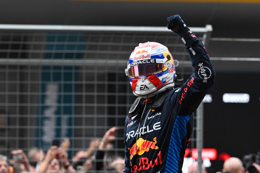 Red Bull Racing's Dutch driver Max Verstappen celebrates after winning the the Formula One Chinese Grand Prix at the Shanghai International Circuit in Shanghai on April 21, 2024. (Photo by Hector RETAMAL / AFP)