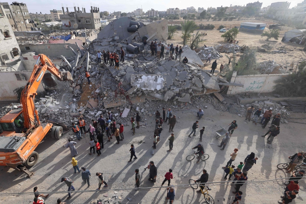 Palestinians inspect the rubble of a building hit in overnight Israeli bombing in Rafah, in the southern Gaza Strip, on April 21, 2024. (Photo by Mohammed Abed / AFP)