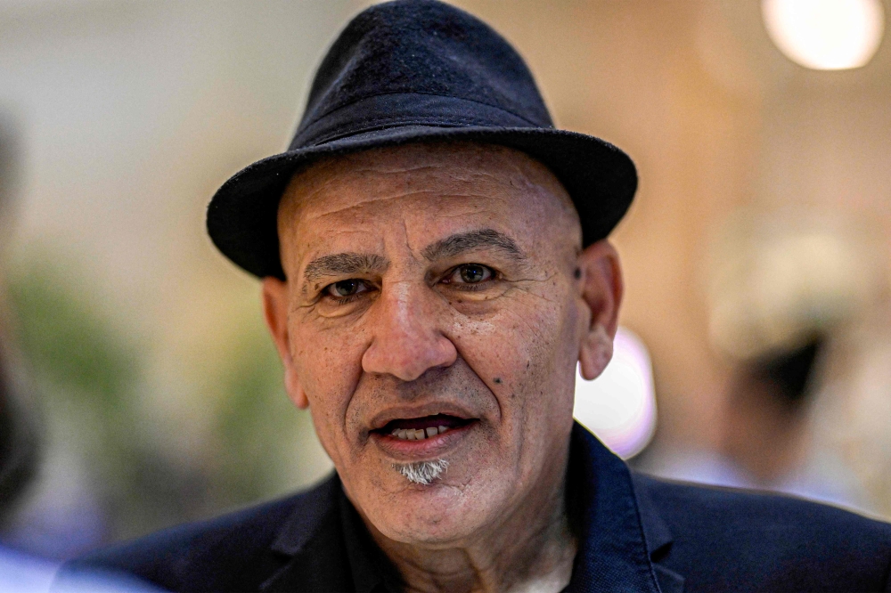 Palestinian film director Rashid Masharawi gives an interview with AFP during the opening ceremony of the eighth edition of the Aswan International Women Film Festival in Egypt's southern city of Aswan on April 20, 2024. (Photo by Khaled Desouki / AFP)