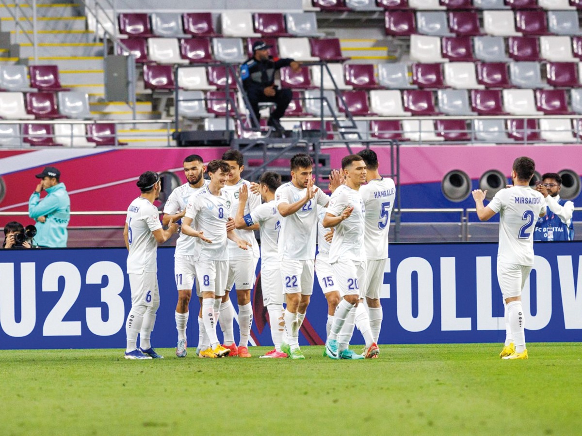 Uzbekistan's players celebrate their goal yesterday. QNA